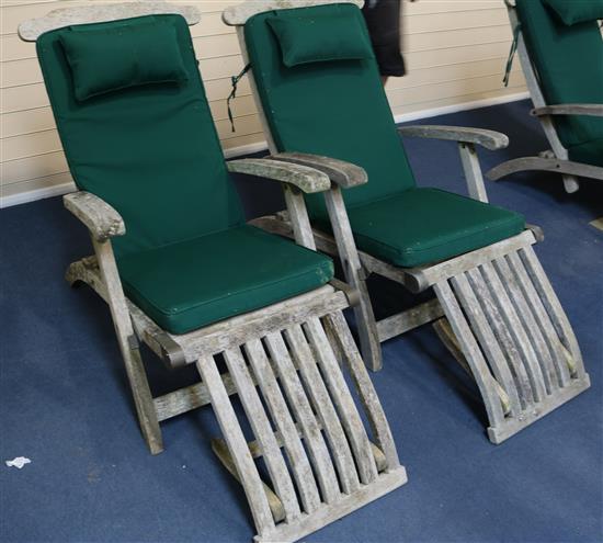 A pair of Indian Ocean teak folding loungers